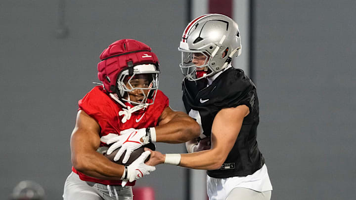 Ohio State Buckeyes quarterback Lincoln Kienholz (3) hands off to running back James Peoples (20) during spring football practice at the Woody Hayes Athletic Center on March 17, 2025.