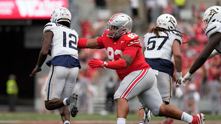 Aug 31, 2024; Columbus, OH, USA; Ohio State Buckeyes defensive tackle Hero Kanu (93) reaches to tackle Akron Zips quarterback Tahj Bullock (12) during the second half of the NCAA football game at Ohio Stadium. Ohio State won 52-6.