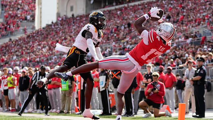 Ohio State Buckeyes wide receiver Carnell Tate (17) catches a touchdown pass behind Grambling State Tigers defensive back Tyrell Raby (5) during the first half of the NCAA football game at Ohio Stadium on Sept. 6, 2025.