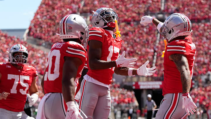 Ohio State Buckeyes wide receiver Carnell Tate (17) celebrates a touchdown catch with wide receiver Brandon Inniss (1) and DUPLICATE***running back James Peoples (20)***linebacker Riley Pettijohn (20) during the NCAA football game against the Texas Longhorns at Ohio Stadium on Aug. 30, 2025.