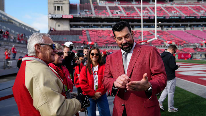 Ohio State Buckeyes head coach Ryan Day talks to former head coach and current Ohio lieutenant governor Jim Tressel prior to the NCAA football game against the Rutgers Scarlet Knights at Ohio Stadium in Columbus on Nov. 22, 2025.