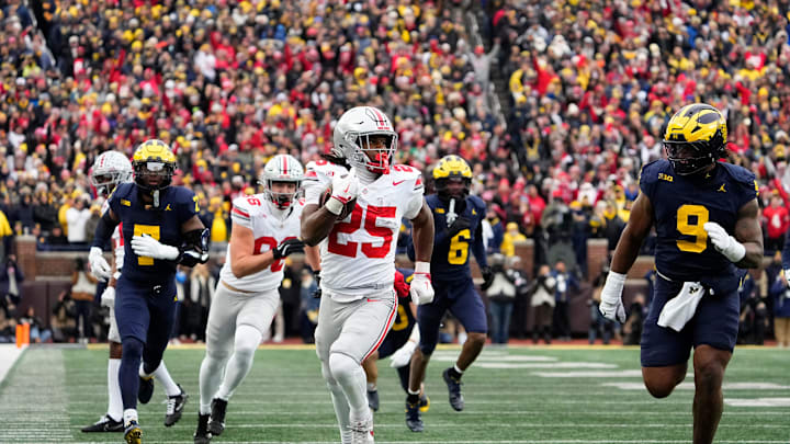 Ohio State Buckeyes running back Bo Jackson (25) runs past Michigan Wolverines defensive end Cameron Brandt (9) during the NCAA football game at Michigan Stadium in Ann Arbor, Mich. on Nov. 29, 2025. Ohio State won 27-9.