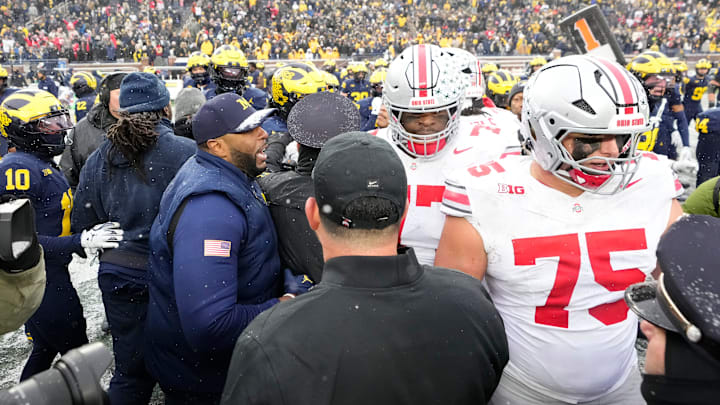 Ohio State Buckeyes head coach Ryan Day and Michigan Wolverines head coach Sherrone Moore separate their players following the NCAA football game at Michigan Stadium in Ann Arbor, Mich. on Nov. 29, 2025. Ohio State won 27-9.