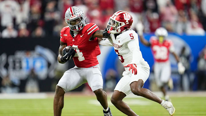 Ohio State Buckeyes wide receiver Jeremiah Smith (4) catches a pass in front of Indiana Hoosiers defensive back D'Angelo Ponds (5) during the first half of the Big Ten Conference championship game at Lucas Oil Stadium in Indianapolis on Dec. 6, 2025.