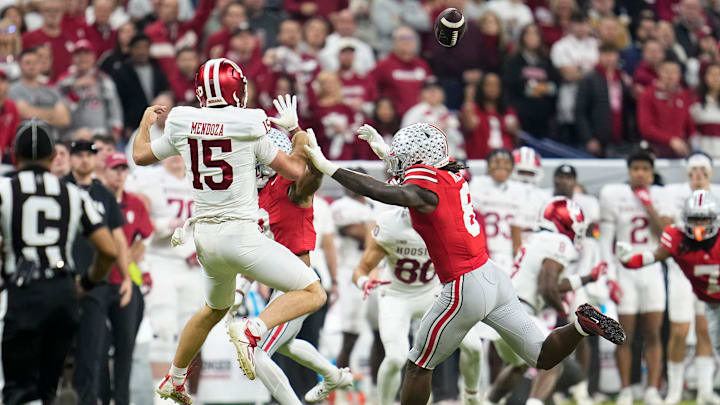 Ohio State Buckeyes linebacker Arvell Reese (8) pressures Indiana Hoosiers quarterback Fernando Mendoza (15) during the first half of the Big Ten Conference championship game at Lucas Oil Stadium in Indianapolis on Dec. 6, 2025.