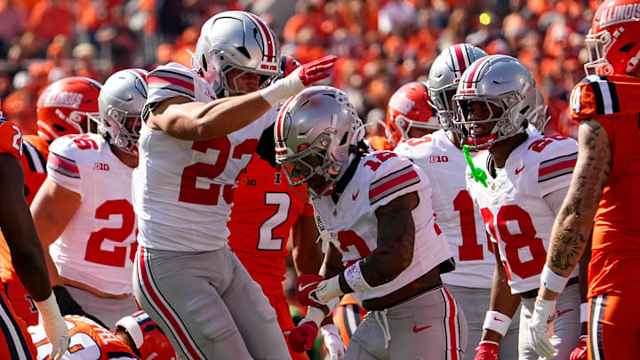 Ohio State Buckeyes linebacker Garrett Stover (23) celebrates a tackle by cornerback Bryce West (12) on a kickoff during the NCAA football game against the Illinois Fighting Illini at Gies Memorial Stadium in Champaign on Oct. 11, 2025. Ohio State won 34-16.