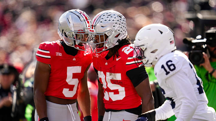 Ohio State Buckeyes wide receiver Mylan Graham (5) celebrates with running back Bo Jackson (25) beside Penn State Nittany Lions tight end Khalil Dinkins (16) during the NCAA football game at Ohio Stadium in Columbus on Nov. 1, 2025.