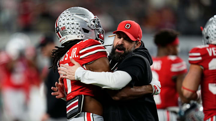 Ohio State Buckeyes defensive coordinator Matt Patricia hugs cornerback Jermaine Mathews Jr. (7) during warm-ups prior to the Cotton Bowl at AT&T Stadium in Arlington, Texas for the College Football Playoff quarterfinal game against the Miami Hurricanes on Dec. 31, 2025.