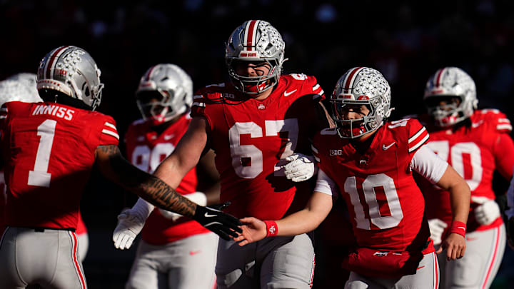 Ohio State Buckeyes quarterback Julian Sayin (10), offensive lineman Austin Siereveld (67) and wide receiver Brandon Inniss (1) celebrate a touchdown during the second half of the NCAA football game against the Rutgers Scarlet Knights at Ohio Stadium in Columbus on Nov. 22, 2025. Ohio State won 42-9.