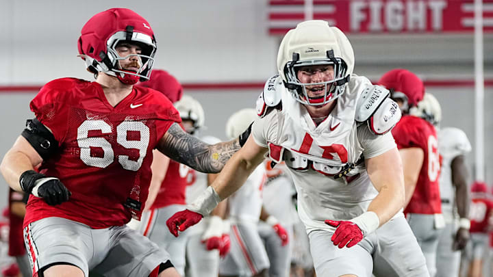 Ohio State Buckeyes defensive end Beau Atkinson (12) runs past offensive lineman Ian Moore (69) during Student Appreciation Day spring practice at the Woody Hayes Athletic Center on April 4, 2026.