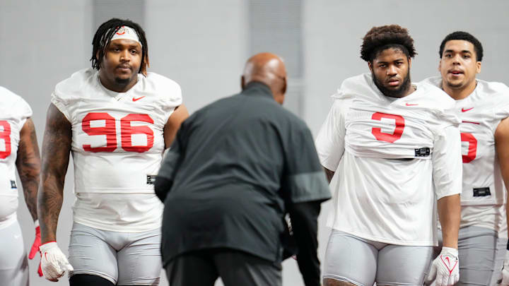 Ohio State Buckeyes defensive end Eddrick Houston (96) and defensive tackle James Smith (3) listen to defensive line coach Larry Johnson during the first day of spring workouts for the 2026 football season at Woody Hayes Athletic Complex in Columbus on March 10, 2026.