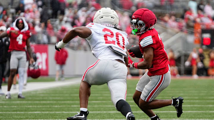 Wide receiver Devin McCuin (3) runs around linebacker Cincere Johnson (20) during the Ohio State football spring game at Ohio Stadium in Columbus on April 18, 2026.