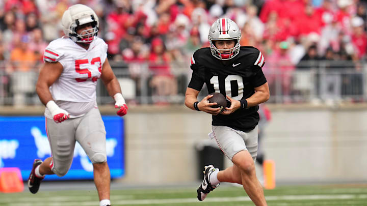 Quarterback Julian Sayin (10) runs away from Defensive lineman Will Smith Jr. (53) during the Ohio State football spring game at Ohio Stadium in Columbus on April 18, 2026.