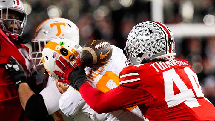 Ohio State Buckeyes defensive end JT Tuimoloau (44) attempts to grab the ball against Tennessee Volunteers quarterback Nico Iamaleava (8) in the second half at Ohio Stadium on Saturday, Dec. 21, 2024 in Columbus, Ohio. Ohio State Buckeyes defensive end JT Tuimoloau (44) attempts to grab the ball against Tennessee Volunteers quarterback Nico Iamaleava (8) in the second half at Ohio Stadium on Saturday, Dec. 21, 2024 in Columbus, Ohio.