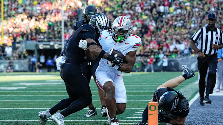 Oct 12, 2024; Eugene, Oregon, USA; Ohio State Buckeyes running back Quinshon Judkins (1) is forced out of bounds by Oregon Ducks defensive back Tysheem Johnson (0) during the first half of the NCAA football game at Autzen Stadium