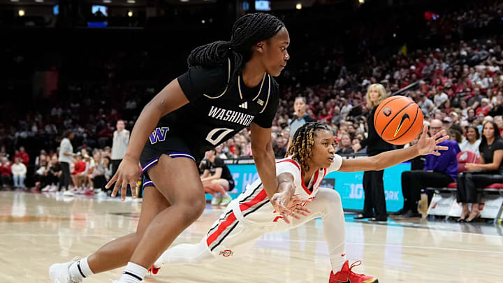 Ohio State Buckeyes guard Jaloni Cambridge (22) and Washington Huskies guard Sayvia Sellers (0) fight for a loose ball during the first half of the NCAA women's basketball game at Value City Arena in Columbus on Feb. 2, 2025.