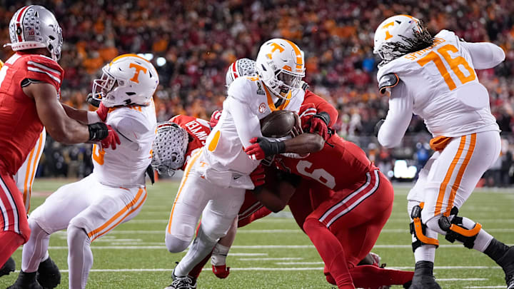 Nico Iamaleava runs for a touchdown during the first half of the College Football Playoff first-round game.