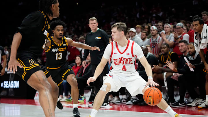 Ohio State Buckeyes guard Gabe Cupps (4) dribbles between Appalachian State Mountaineers center Luke Wilson (3) and guard Kasen Jennings (13) during the NCAA men's basketball game at Value City Arena in Columbus on Nov. 11, 2025.