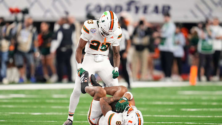 Miami Hurricanes defensive back Jakobe Thomas (8) hangs onto the football in front of defensive back Dylan Day (23) after making an interception to seal the Cotton Bowl at AT&T Stadium in Arlington, Texas for the College Football Playoff quarterfinal game against the Ohio State Buckeyes on Dec. 31, 2025. Ohio State lost 24-14. Miami Hurricanes defensive back Jakobe Thomas (8) hangs onto the football in front of defensive back Dylan Day (23) after making an interception to seal the Cotton Bowl at AT&T Stadium in Arlington, Texas for the College Football Playoff quarterfinal game against the Ohio State Buckeyes on Dec. 31, 2025. Ohio State lost 24-14.