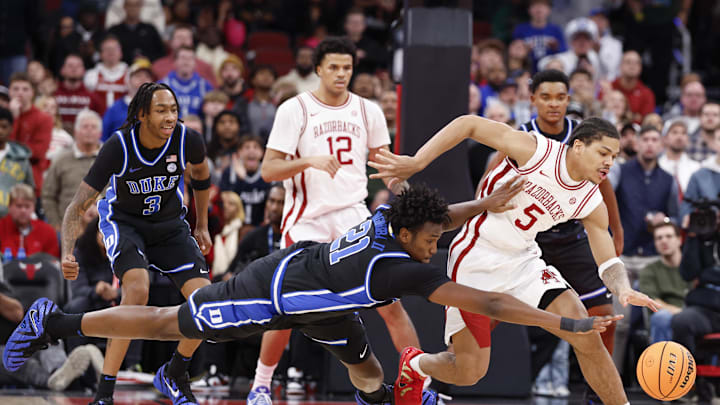 Nov 27, 2025; Chicago, Illinois, USA; Arkansas Razorbacks guard Darius Acuff Jr. (5) battles for the ball with Duke Blue Devils center Patrick Ngongba (21) during the second half at United Center. Mandatory Credit: Kamil Krzaczynski-Imagn Images