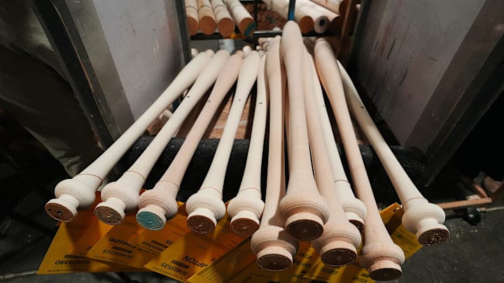 A stack of torpedo bats after they came out of a baseball bat lathe at the Louisville Slugger Museum & Factory in Louisville, Ky. on Mar. 31, 2025.