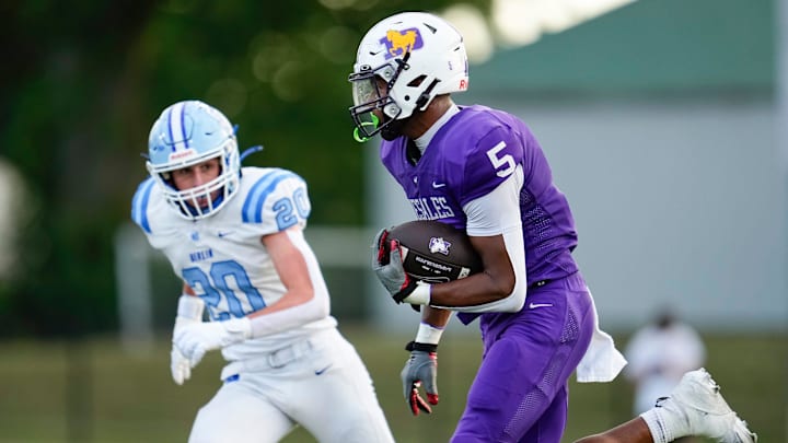 St. Francis DeSales tight end Jordan Karhoff (5) runs past Olentangy Berlin linebacker Chase Arnold (20) during Week 1 of high school football at DeSales High School on Aug. 22, 2025.