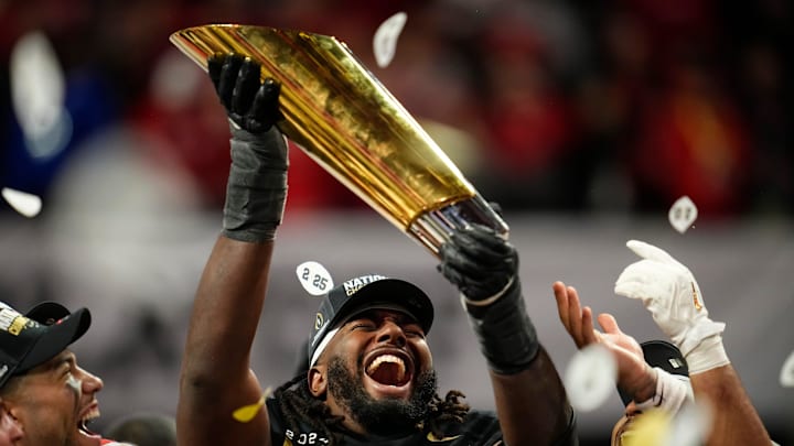Ohio State Buckeyes wide receiver Jeremiah Smith (4) holds the trophy following the 34-23 win over the Notre Dame Fighting Irish to win the College Football Playoff National Championship at Mercedes-Benz Stadium in Atlanta on Jan. 21, 2025.