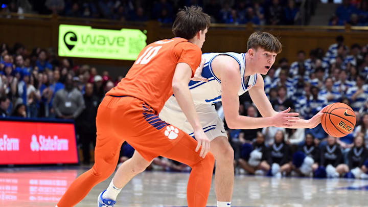 Feb 14, 2026; Durham, North Carolina, USA; Duke Blue Devils forward Nikolas Khamenia (14) controls the ball in front of Clemson Tigers forward Jake Whalin (10) during the second half at Cameron Indoor Stadium. Mandatory Credit: Rob Kinnan-Imagn Images
