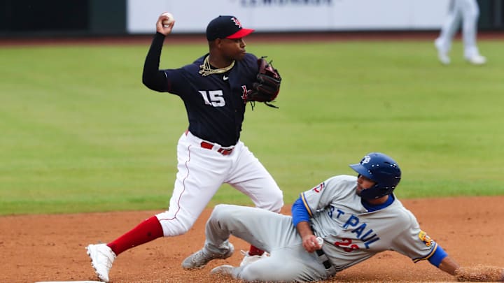 The Louisville Bats Alfredo Rodriguez (15) threw to first to complete the double play.