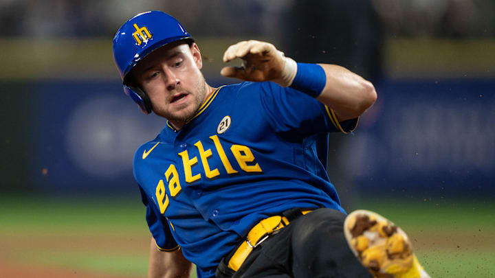 Sep 15, 2023; Seattle, Washington, USA; Seattle Mariners left fielder Jarred Kelenic (10) slides into third base against the Los Angeles Dodgers at T-Mobile Park. Mandatory Credit: Stephen Brashear-Imagn Images