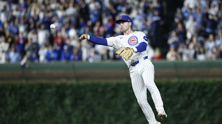 Chicago Cubs second baseman Nico Hoerner (2) throws to first baseman Michael Busch for a final out.