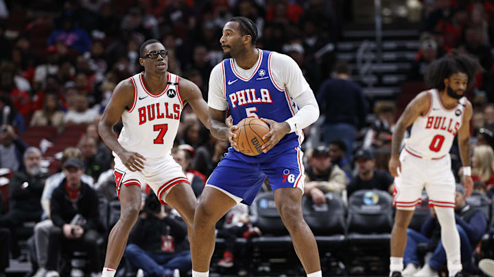 Dec 8, 2024; Chicago, Illinois, USA; Philadelphia 76ers center Andre Drummond (5) looks to pass the ball against Chicago Bulls forward Jalen Smith (7) during the first half at United Center. Mandatory Credit: Kamil Krzaczynski-Imagn Images