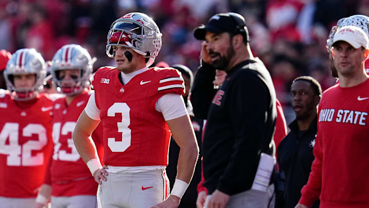 Ohio State Buckeyes quarterback Lincoln Kienholz (3) and head coach Ryan Day watch during the second half of the NCAA football game against the Rutgers Scarlet Knights at Ohio Stadium in Columbus on Nov. 22, 2025. Ohio State won 42-9.
