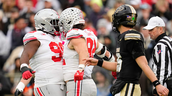 Ohio State Buckeyes defensive end Caden Curry (92) and defensive tackle Kayden McDonald (98) celebrate behidn Purdue Boilermakers quarterback Ryan Browne (15) during the NCAA football game at Ross-Ade Stadium in West Lafayette, Ind. on Nov. 8, 2025.