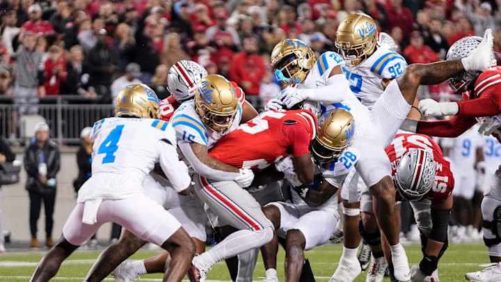 UCLA Bruins defensive back Scooter Jackson (28) tries to stop Ohio State Buckeyes running back Bo Jackson (25) during the NCAA football game at Ohio Stadium in Columbus on Nov. 15, 2025.
