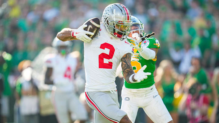 Ohio State Buckeyes wide receiver Emeka Egbuka (2) catches a touchdown in front of Oregon Ducks defensive back Brandon Johnson (3) during the first half of the College Football Playoff quarterfinal at the Rose Bowl in Pasadena, Calif. on Jan. 1, 2025.