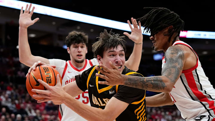 Ohio State Buckeyes forward Devin Royal (21) defends Valparaiso Beacons forward Cooper Schwieger (13) during the during the first half of the NCAA men's basketball game at Value City Arena in Columbus on Dec. 17, 2024.