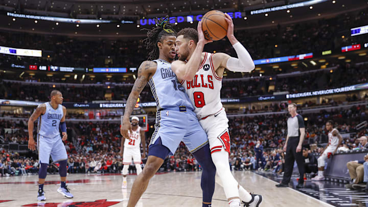 Memphis Grizzlies guard Ja Morant (12) defends against Chicago Bulls guard Zach LaVine (8) during the second half at United Center. Mandatory Credit: Kamil Krzaczynski-Imagn Images