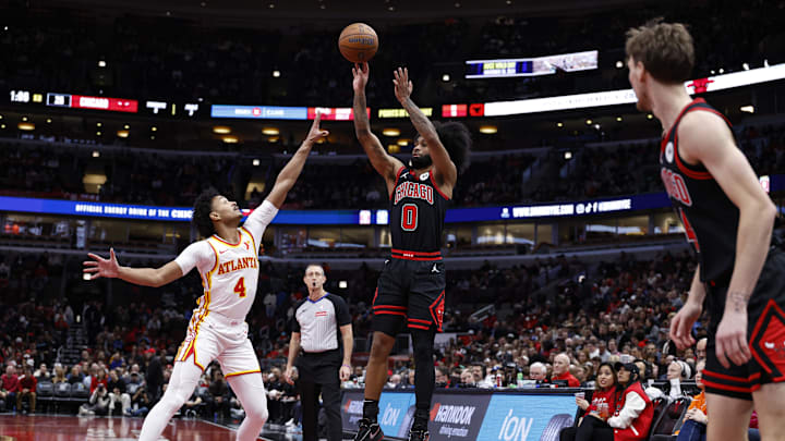 Nov 22, 2024; Chicago, Illinois, USA; Chicago Bulls guard Coby White (0) shoots against Atlanta Hawks guard Kobe Bufkin (4) during the first half at United Center. Mandatory Credit: Kamil Krzaczynski-Imagn Images