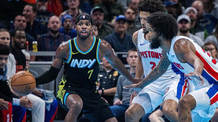 Nov 24, 2023; Indianapolis, Indiana, USA; Indiana Pacers guard Buddy Hield (7) dribbles the ball while Detroit Pistons guard Cade Cunningham (2) defends in the first quarter at Gainbridge Fieldhouse. Mandatory Credit: Trevor Ruszkowski-USA TODAY Sports