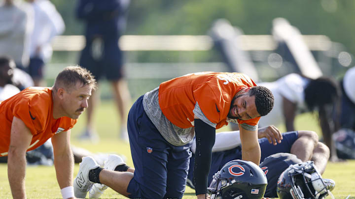 Caleb Williams goes through stretching at Halas Hall in training camp.
