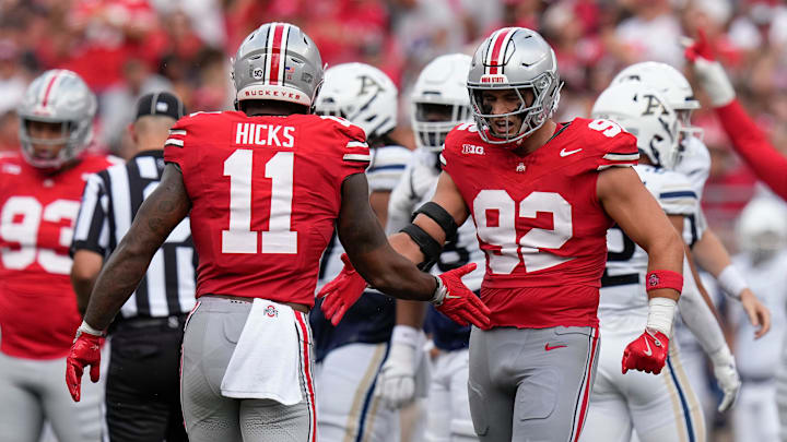 Aug 31, 2024; Columbus, OH, USA; Ohio State Buckeyes defensive end Caden Curry (92) celebrates a sack by linebacker C.J. Hicks (11) during the first half of the NCAA football game against the Akron Zips at Ohio Stadium.