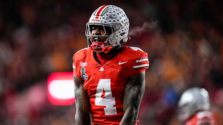 Ohio State Buckeyes wide receiver Jeremiah Smith (4) celebrates a touchdown catch during the second half of the College Football Playoff first round game against the Tennessee Volunteers at Ohio Stadium in Columbus on Dec. 22, 2024. Ohio State won 42-17.