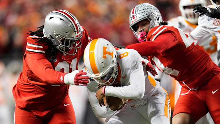 Ohio State Buckeyes defensive tackle Tyleik Williams (91) and defensive end JT Tuimoloau (44) sack Tennessee Volunteers quarterback Nico Iamaleava (8) during the first half of the College Football Playoff first round game at Ohio Stadium in Columbus on Dec. 21, 2024.