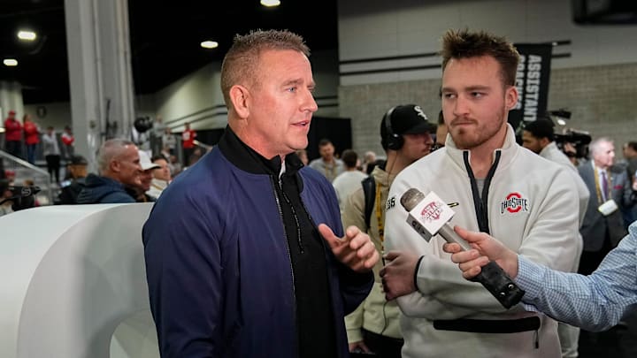 Ohio State Buckeyes tight end Zak Herbstreit listens as his dad, Kirk Herbstreit, does an interview during Media Day for the College Football Playoff against the Notre Dame Fighting Irish at the Georgia World Congress Center in Atlanta on Jan. 18, 2025.