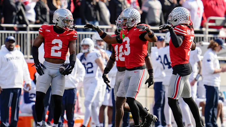 Ohio State Buckeyes defensive back Caleb Downs (2) celebrates an interception with cornerback Lorenzo Styles Jr. (3) and cornerback Jermaine Mathews Jr. (7) during the NCAA football game against the Penn State Nittany Lions at Ohio Stadium in Columbus on Nov. 1, 2025.