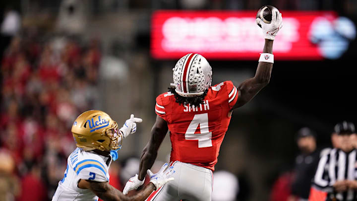 Ohio State Buckeyes wide receiver Jeremiah Smith (4) makes a one-handed catch in front of UCLA Bruins defensive back Andre Jordan Jr. (2) during the NCAA football game at Ohio Stadium in Columbus on Nov. 15, 2025.