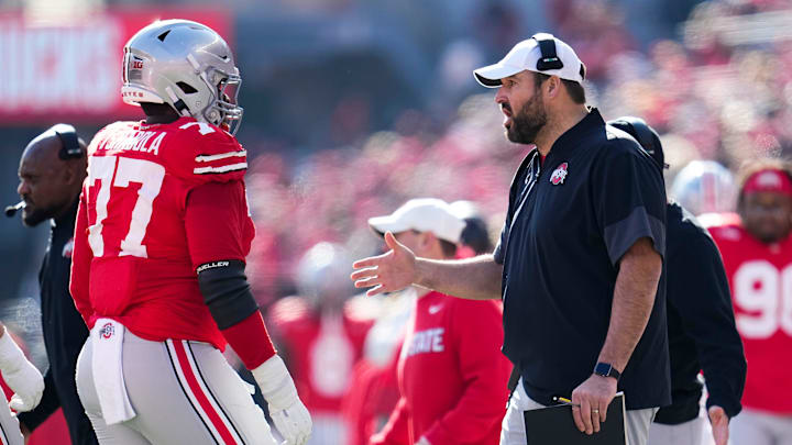 Ohio State Buckeyes offensive line coach Tyler Bowen talks to offensive lineman Tegra Tshabola (77) during the NCAA football game at Ohio Stadium in Columbus on Nov. 22, 2025. Ohio State won 42-9.