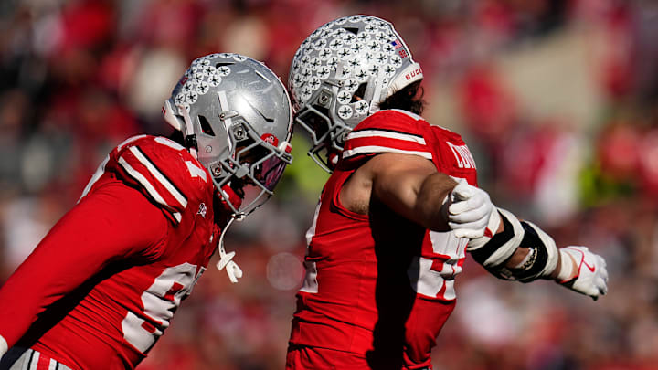 Ohio State Buckeyes defensive end Caden Curry (92) celebrates a turnover with defensive end Kenyatta Jackson Jr. (97) during the second half of the NCAA football game at Ohio Stadium in Columbus on Nov. 22, 2025. Ohio State won 42-9.