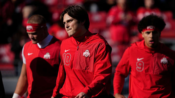 Ohio State Buckeyes quarterback Julian Sayin (10) warms up with quarterback Lincoln Kienholz (3) and quarterback Tavien St. Clair (9) prior to the NCAA football game against the Rutgers Scarlet Knights at Ohio Stadium in Columbus on Nov. 22, 2025. Ohio State Buckeyes quarterback Julian Sayin (10) warms up with quarterback Lincoln Kienholz (3) and quarterback Tavien St. Clair (9) prior to the NCAA football game against the Rutgers Scarlet Knights at Ohio Stadium in Columbus on Nov. 22, 2025.